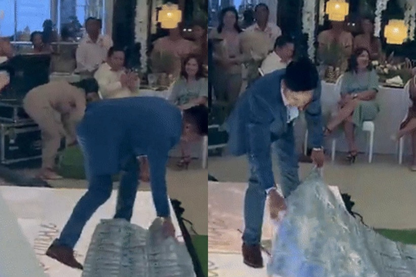 Chú rể mở vali chứa tấm khăn choàng đặc biệt sau đó quàng lên vai vợ trong sự hò reo, vỗ tay của khách mời. Ảnh: Saostar.