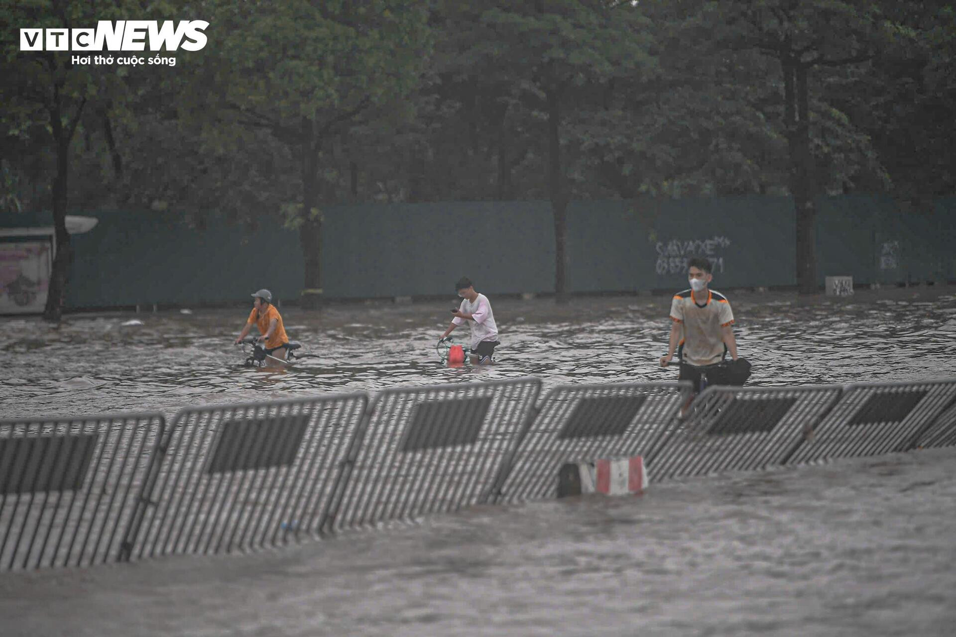 Mưa lớn biến Mỹ Đình thành biển nước, dân trả trăm nghìn thuê kéo xe qua điểm ngập - 1