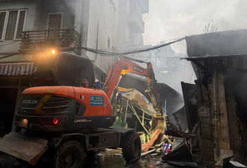 Dùng máy xúc phá dỡ, mở đường cho cảnh sát dập tắt đám cháy chợ ở Hà Nội