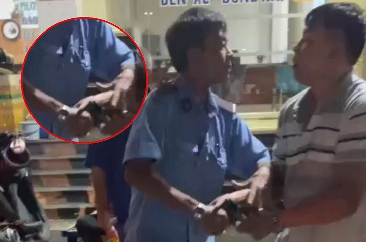 Hình ảnh bảo vệ bến xe dùng súng điện giải quyết mâu thuẫn.