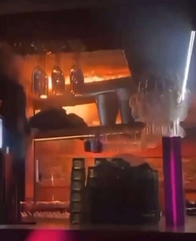 Dramatic footage shows enormous flames rapidly spreading over the ceiling of the cramped bar.