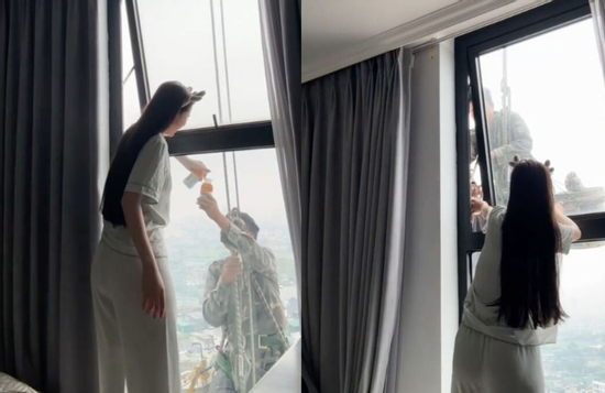 Mát lòng cảnh cô gái mời nước anh thợ treo mình giữa trời nóng lau kính cao ốc