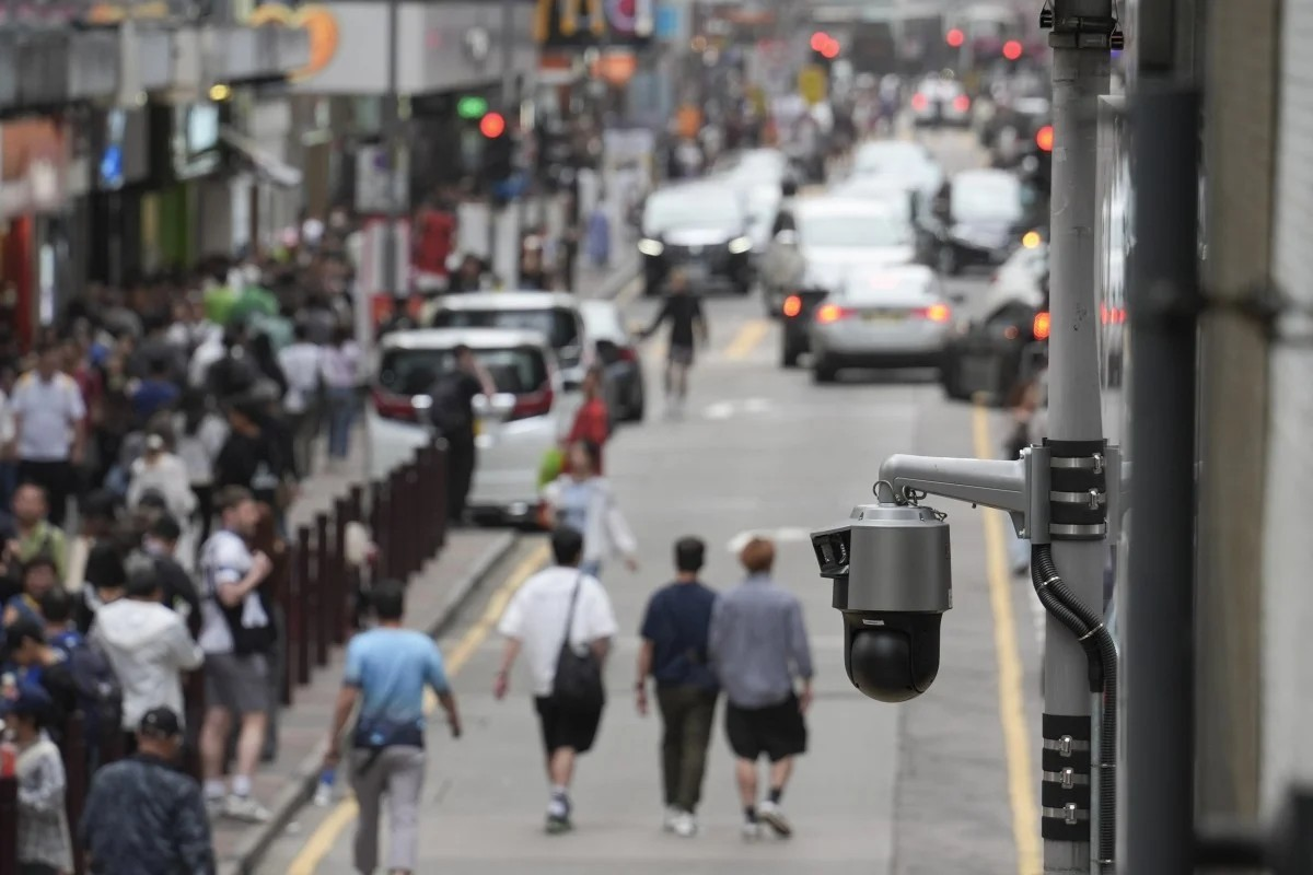 A person passes by surveillance cameras on the street in Beijing, China, 22 May 2019. [[Roman Piliey/EPA/EFE]]