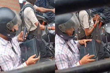 Bức ảnh gây bão mạng toàn thế giới: Mở laptop làm việc khi xe máy chờ đèn đỏ